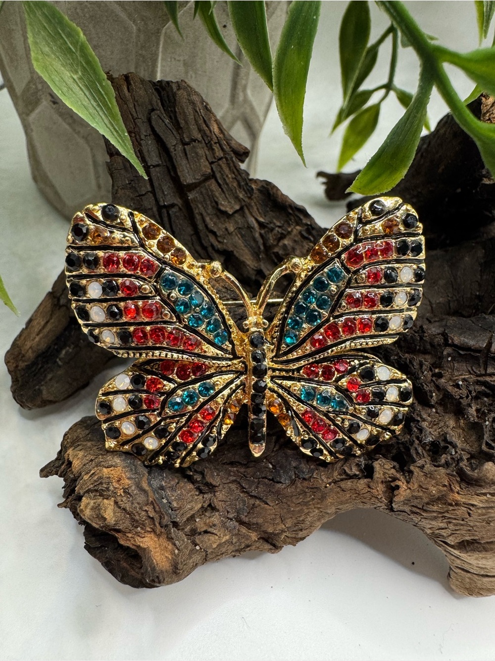 Butterfly brooch, EUC. Modern, gold-tone with multicolored rhinestones.